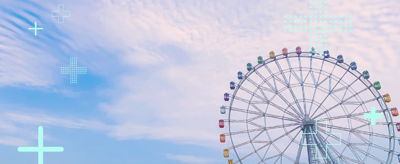 A Ferris wheel against a blue sky with clouds. 
