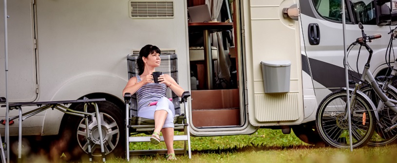 woman sitting in front of RV