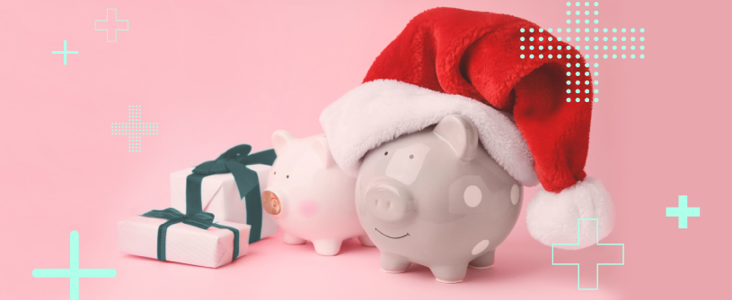 Two piggy banks (one wearing a Santa hat) next to two wrapped gifts