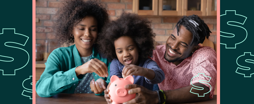 Parents holding a piggy bank while their child puts coins inside.