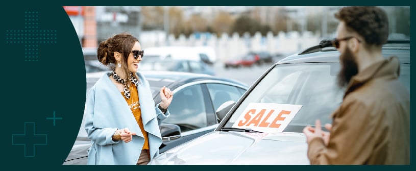 Woman in front of a car for sale