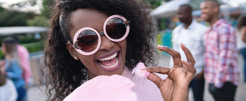 Woman enjoys cotton candy at a festival in PA